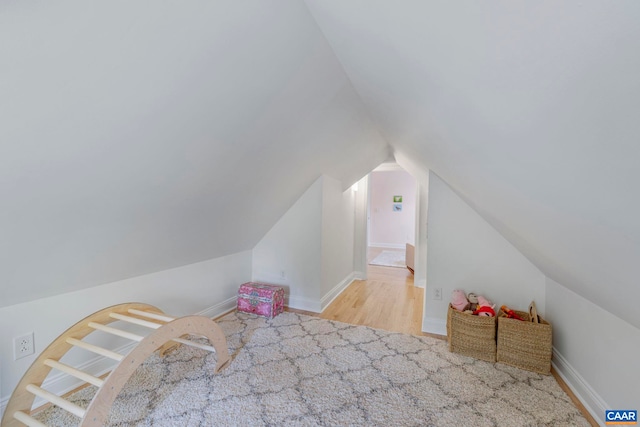 playroom featuring lofted ceiling and wood finished floors