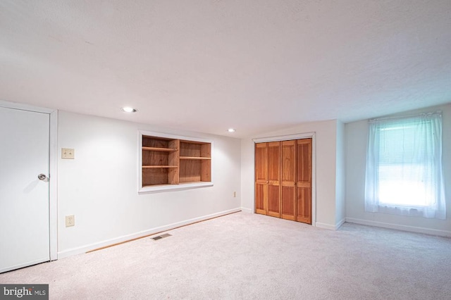  - unfurnished bedroom with carpet, a closet, and recessed lighting