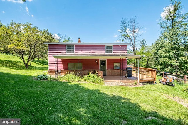  - rear view of house featuring a yard