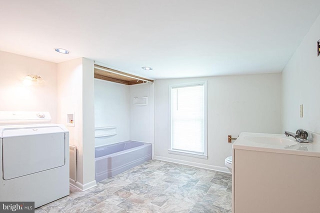  - bathroom featuring washer / dryer and vanity