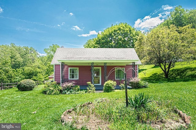  - ranch-style home featuring covered porch and a shingled roof