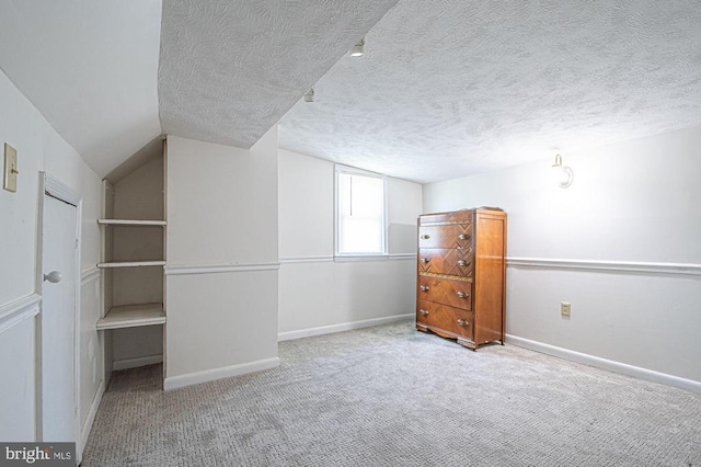  - bonus room with carpet floors and a textured ceiling