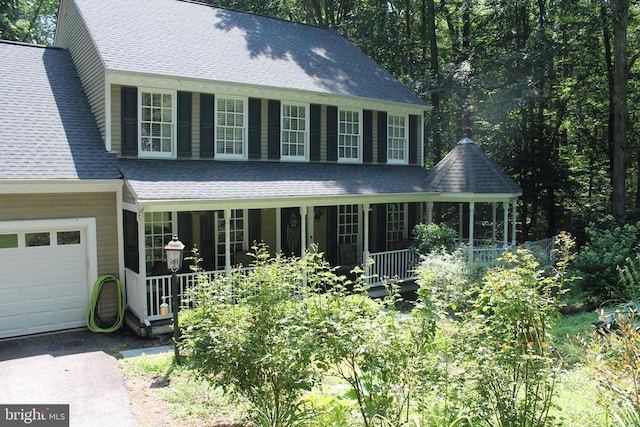 9603 Conaty Cir, Spotsylvania, VA 22553 - colonial-style house with covered porch, a shingled roof, and a garage