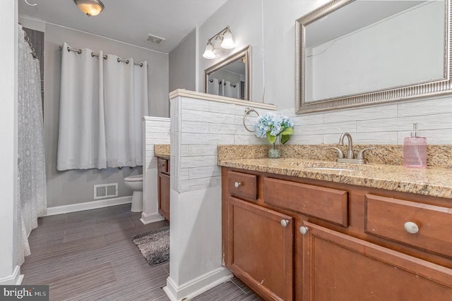 9603 Conaty Cir, Spotsylvania, VA 22553 - bathroom featuring vanity, backsplash, and wood finished floors