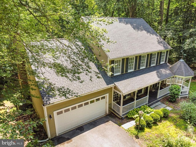 9603 Conaty Cir, Spotsylvania, VA 22553 - view of front of home with covered porch, a shingled roof, asphalt driveway, and a garage