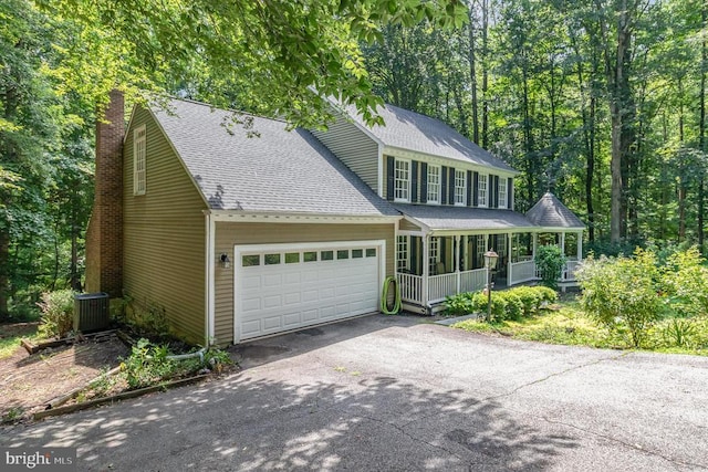 9603 Conaty Cir, Spotsylvania, VA 22553 - view of front of house featuring covered porch, a garage, a chimney, driveway, and roof with shingles