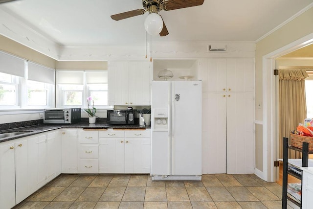 1601 Brunswick Rd, Waynesboro, VA 22980 - kitchen with white fridge with ice dispenser, a ceiling fan, dark countertops, white cabinetry, and black microwave