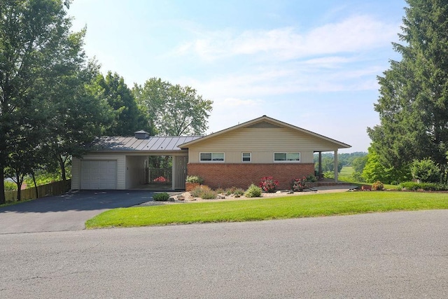1601 Brunswick Rd, Waynesboro, VA 22980 - single story home featuring asphalt driveway, brick siding, an attached garage, a standing seam roof, and a carport
