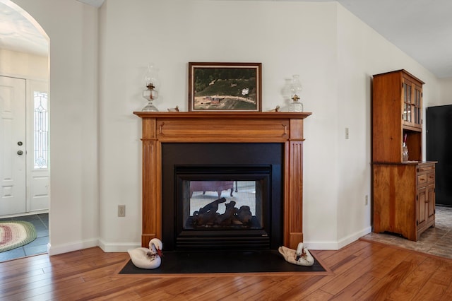 5409 Smith Creek Rd, New Market, VA 22844 - detailed view of wood finished floors, a multi sided fireplace, arched walkways, and freestanding refrigerator
