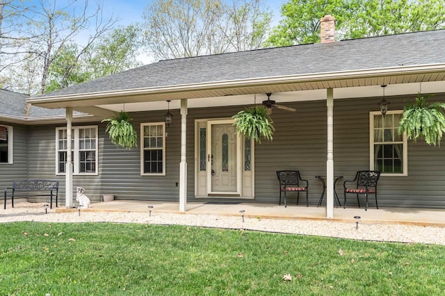 5409 Smith Creek Rd, New Market, VA 22844 - view of exterior entry featuring a porch, a ceiling fan, a yard, a chimney, and a shingled roof
