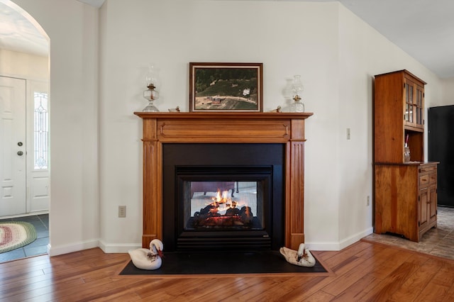 5409 Smith Creek Rd, New Market, VA 22844 - detailed view of wood finished floors, arched walkways, a multi sided fireplace, and freestanding refrigerator