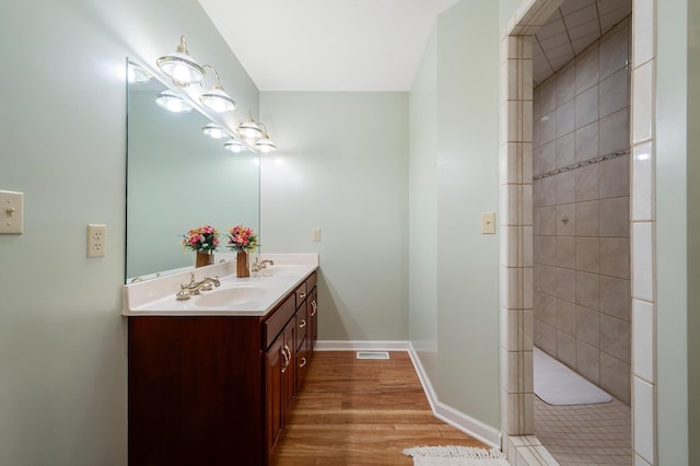 5409 Smith Creek Rd, New Market, VA 22844 - full bathroom featuring double vanity, wood finished floors, and tiled shower