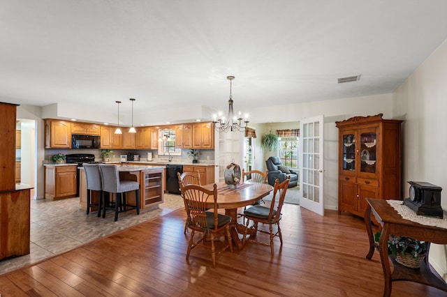 5409 Smith Creek Rd, New Market, VA 22844 - dining area featuring a chandelier, hardwood / wood-style floors, and a wood stove