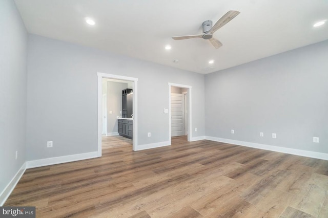 3200 Lakeview Pkwy, Locust Grove, VA 22508 - unfurnished bedroom with wood finished floors, a walk in closet, baseboards, recessed lighting, and ensuite bath