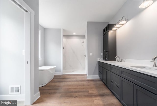 3200 Lakeview Pkwy, Locust Grove, VA 22508 - bathroom featuring a marble finish shower, a freestanding tub, wood finished floors, baseboards, and double vanity