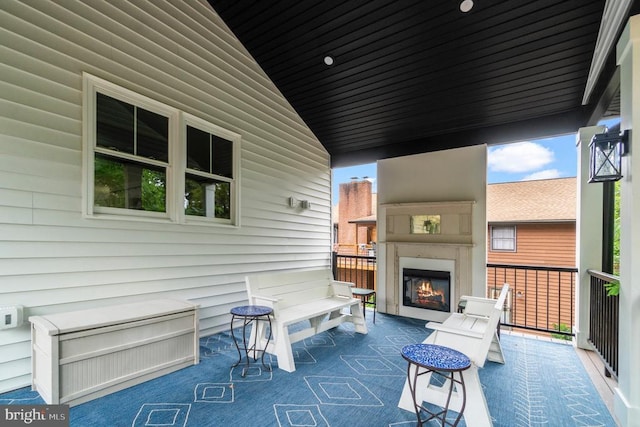 view of patio featuring a glass covered fireplace