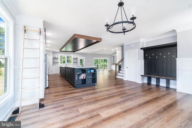 3200 Lakeview Pkwy, Locust Grove, VA 22508 - unfurnished living room with a chandelier, light wood-style floors, ornamental molding, and stairs