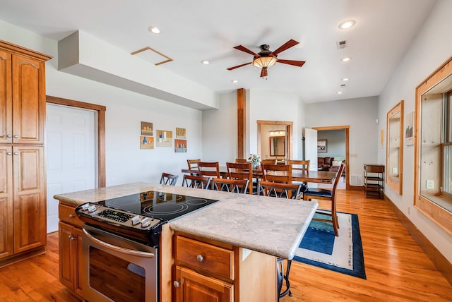 928 Melrose Rd, Rockingham, VA 22802 - kitchen featuring ceiling fan, light wood-style floors, visible vents, and stainless steel range with electric cooktop