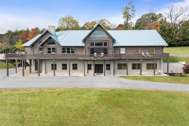928 Melrose Rd, Rockingham, VA 22802 - rear view of house with stucco siding, log siding, a chimney, a yard, and a patio area