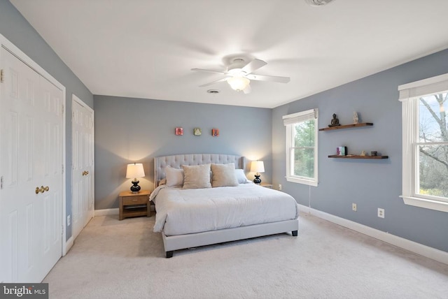bedroom with multiple windows, carpet floors, and baseboards