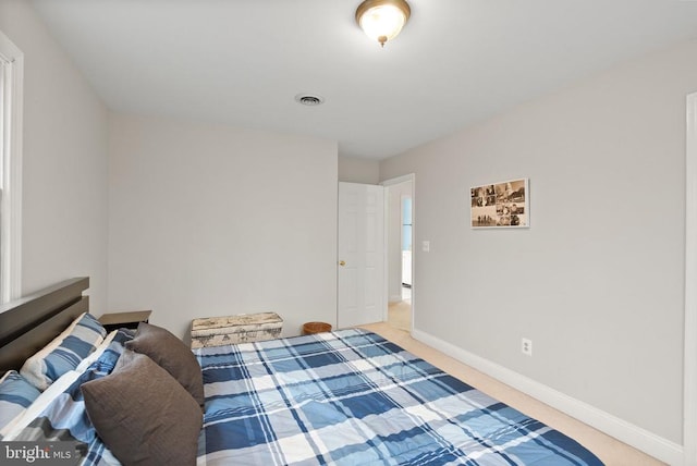 bedroom with baseboards and carpet floors