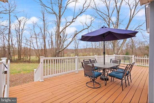 wooden terrace featuring outdoor dining space