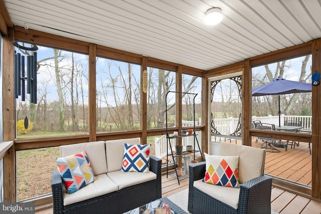 sunroom / solarium with an outdoor hangout area, outdoor dining area, and healthy amount of natural light