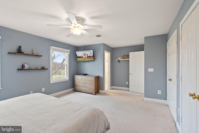 bedroom featuring light carpet, baseboards, and ceiling fan