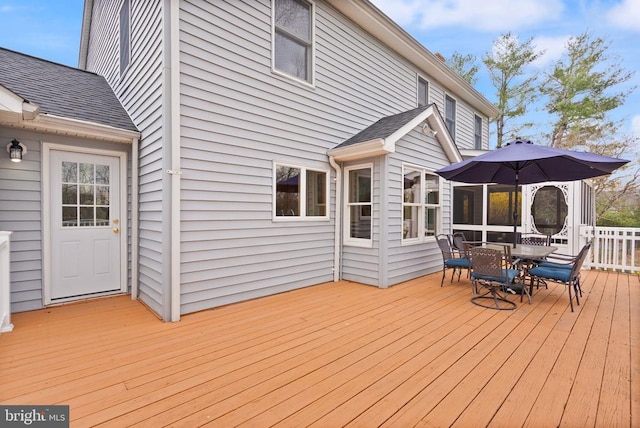 wooden terrace featuring outdoor dining area