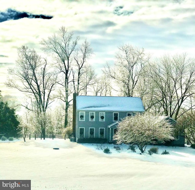 colonial house featuring a chimney