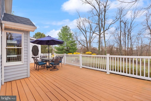 wooden deck featuring outdoor dining space