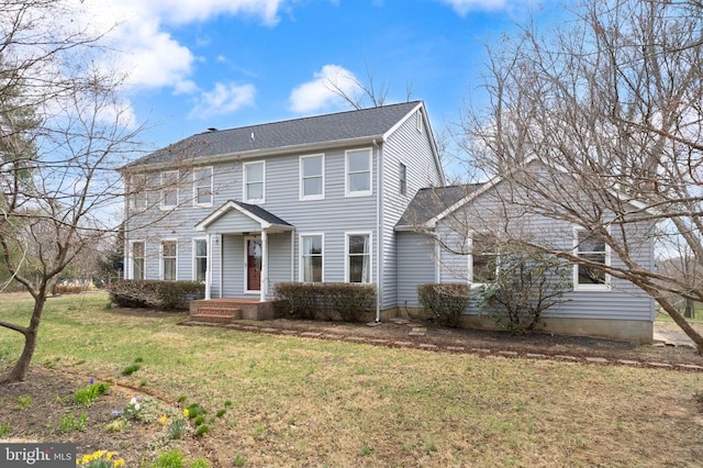 colonial inspired home featuring a front lawn