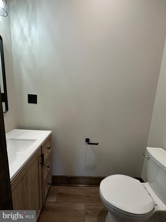 152 Susan Ln, Stanley, VA 22851 - bathroom with toilet, wood finished floors, vanity, and baseboards