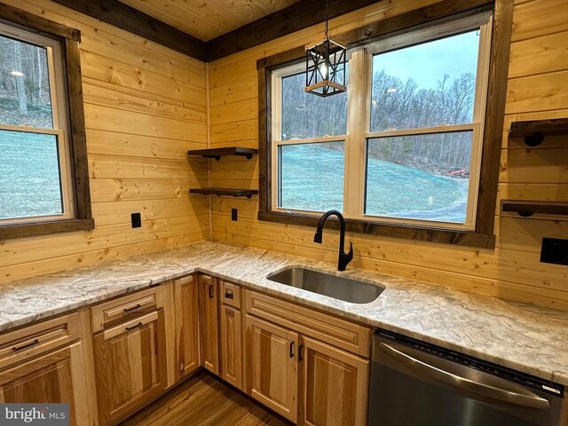 152 Susan Ln, Stanley, VA 22851 - kitchen featuring stainless steel dishwasher, a sink, wood walls, healthy amount of natural light, and light stone countertops