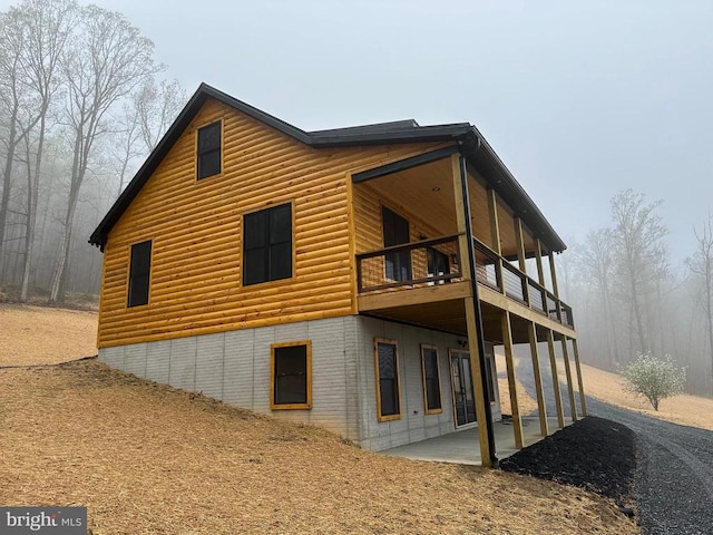 152 Susan Ln, Stanley, VA 22851 - rear view of property with faux log siding, a patio area, and a balcony