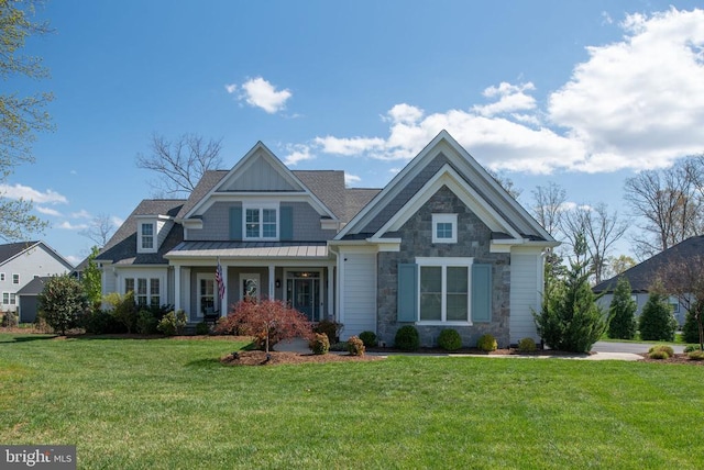 10605 Springvale Ln, Spotsylvania, VA 22551 - craftsman inspired home with a front yard, stone siding, a standing seam roof, and metal roof