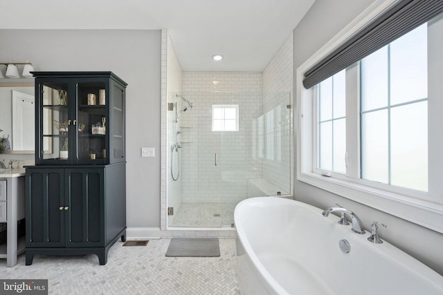 10605 Springvale Ln, Spotsylvania, VA 22551 - bathroom with a shower stall, a freestanding tub, tile patterned flooring, vanity, and recessed lighting