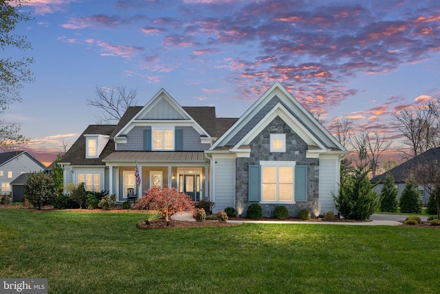 10605 Springvale Ln, Spotsylvania, VA 22551 - back of property featuring a lawn, stone siding, a standing seam roof, covered porch, and metal roof