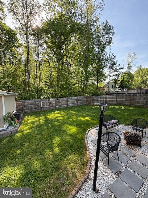 view of yard featuring an outdoor fire pit and a patio