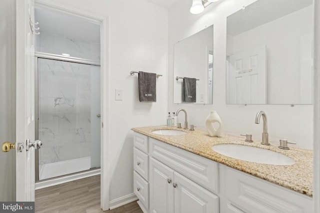 10804 Cobblestone Dr, Spotsylvania, VA 22553 - full bath featuring double vanity, a marble finish shower, and wood finished floors
