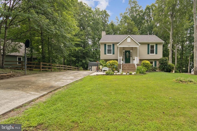 10804 Cobblestone Dr, Spotsylvania, VA 22553 - split foyer home with concrete driveway, a chimney, and view of wooded area