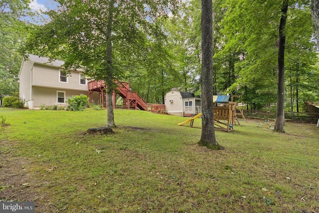 10804 Cobblestone Dr, Spotsylvania, VA 22553 - view of grassy yard featuring a playground, stairway, a storage unit, a deck, and view of scattered trees