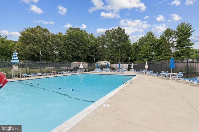 10804 Cobblestone Dr, Spotsylvania, VA 22553 - community pool featuring a patio area and view of scattered trees
