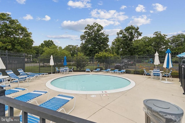 10804 Cobblestone Dr, Spotsylvania, VA 22553 - community pool featuring a patio area and view of wooded area