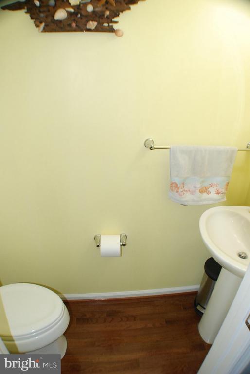  - bathroom with wood finished floors and toilet