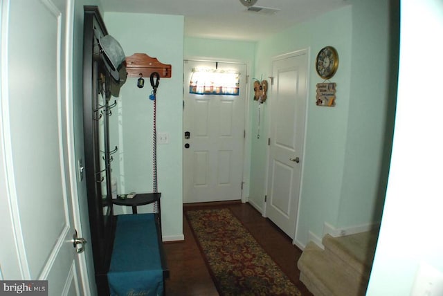 - doorway with baseboards and dark wood-type flooring