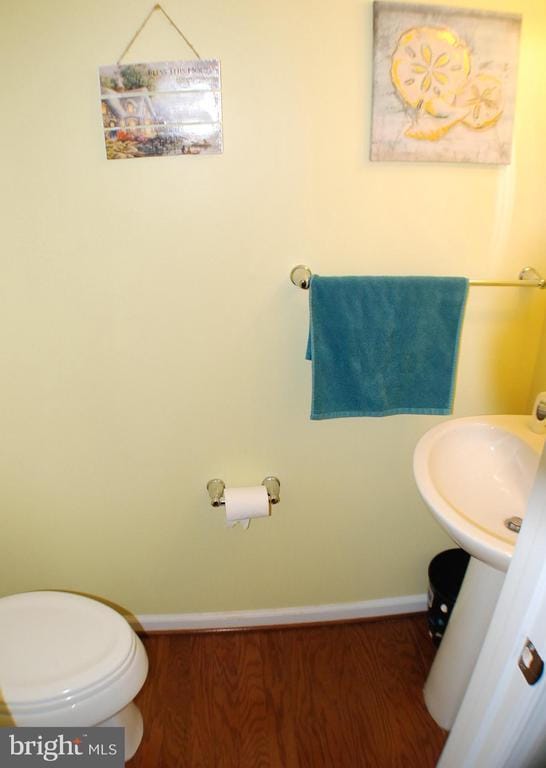  - half bath with wood finished floors and baseboards