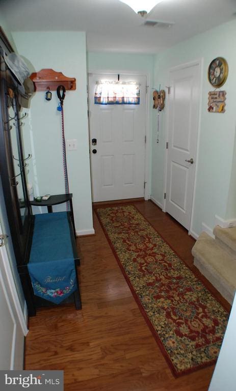  - doorway with wood finished floors