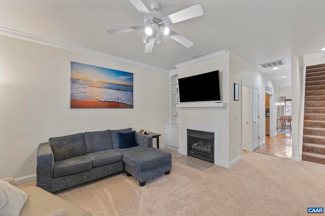 1103 Druid Ave Unit D, Charlottesville, VA 22902 - living area with stairs, ceiling fan, carpet floors, a fireplace with flush hearth, and baseboards