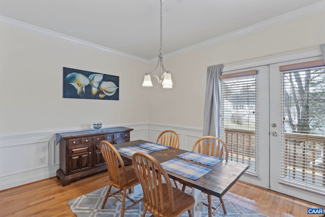 1103 Druid Ave Unit D, Charlottesville, VA 22902 - dining space with ornamental molding, light wood-type flooring, a decorative wall, french doors, and wainscoting